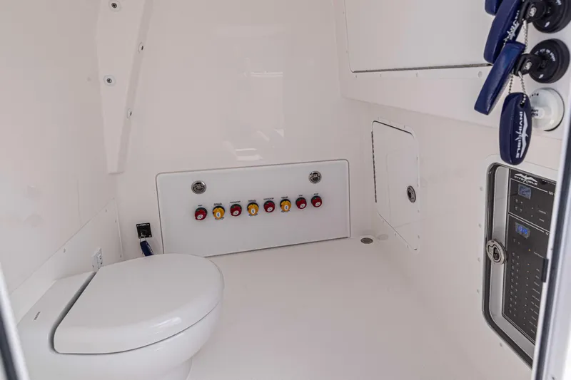  Yacht Photos Pics Interior of 2025 Invincible 35 Catamaran featuring a modern marine toilet and control panel.