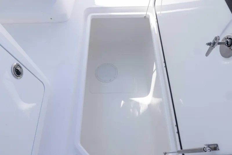  Yacht Photos Pics Spacious storage compartment on 2025 Invincible 35 Catamaran, featuring sleek white interior design.