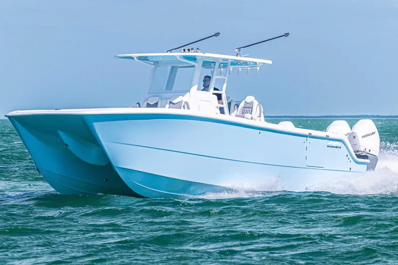  Yacht Photos Pics 2025 Invincible 35 Catamaran cruising on open water, showcasing sleek design and powerful engines.