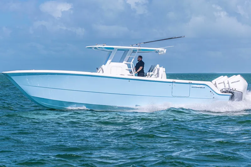  Yacht Photos Pics 2025 Invincible 35 Catamaran cruising on open water under a clear sky.