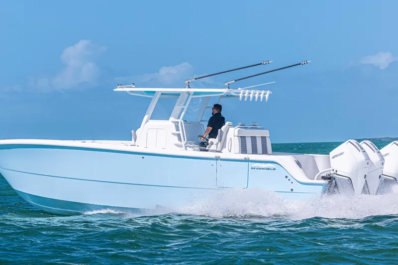  Yacht Photos Pics 2025 Invincible 35 Catamaran cruising on open water, showcasing sleek design and powerful engines.