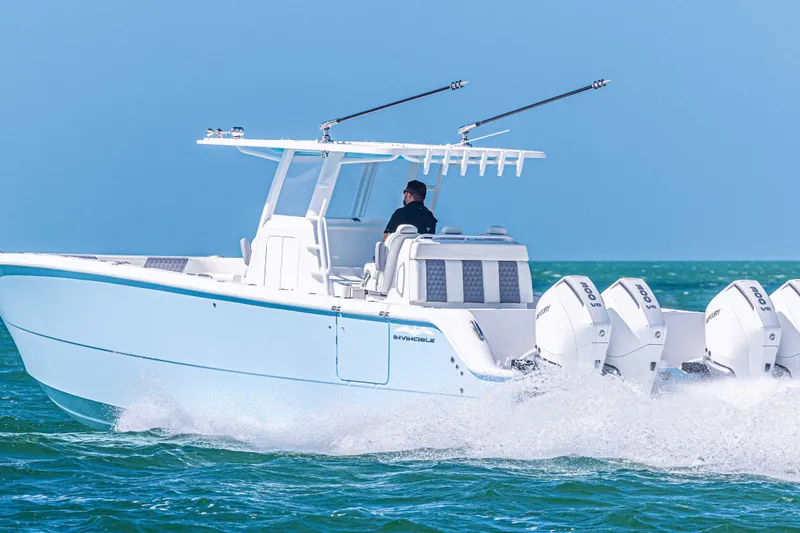  Yacht Photos Pics 2025 Invincible 35 Catamaran cruising on open water with powerful outboard engines.