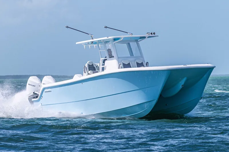  Yacht Photos Pics 2025 Invincible 35 Catamaran cruising on open water, showcasing sleek design and powerful engines.