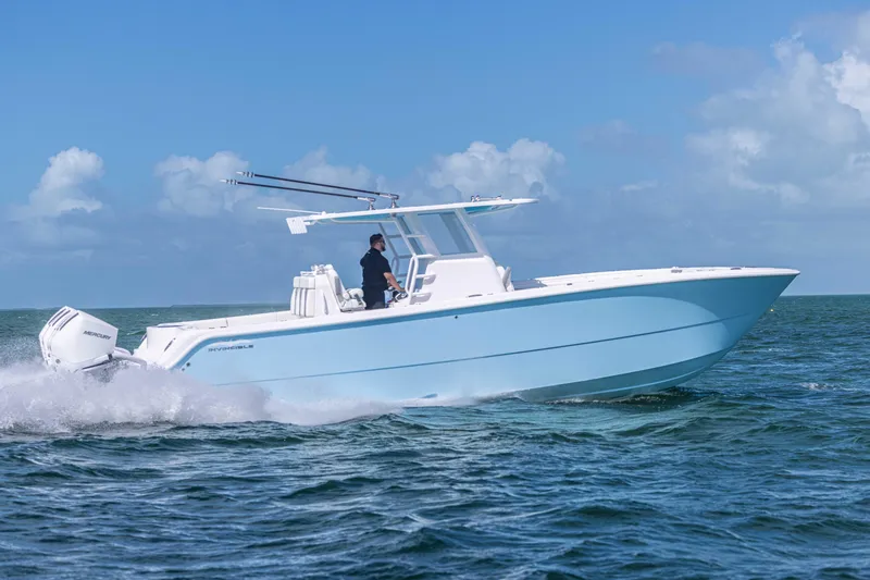  Yacht Photos Pics 2025 Invincible 35 Catamaran cruising on open water under clear skies.