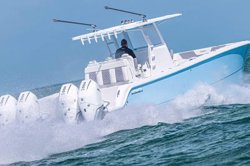  Yacht Photos Pics 2025 Invincible 35 Catamaran speeding on ocean, showcasing powerful engines and sleek design.