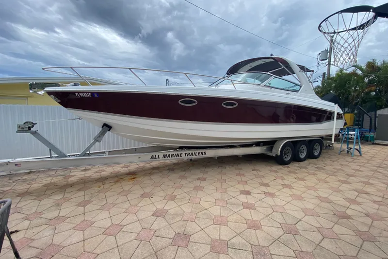  Yacht Photos Pics 2009 Formula 330 Sun Sport boat on trailer, parked on a paved driveway.