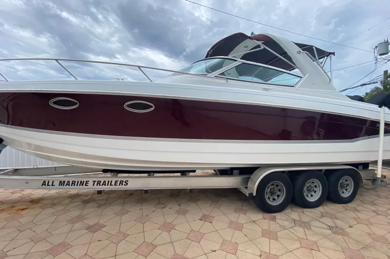  Yacht Photos Pics 2009 Formula 330 Sun Sport boat on trailer, side view under cloudy sky.