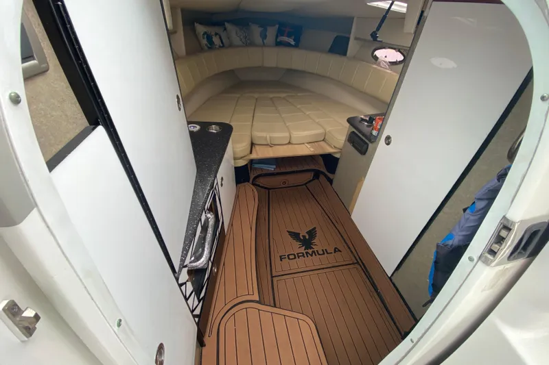  Yacht Photos Pics 2009 Formula 330 Sun Sport cabin interior with beige seating and wood-style flooring.