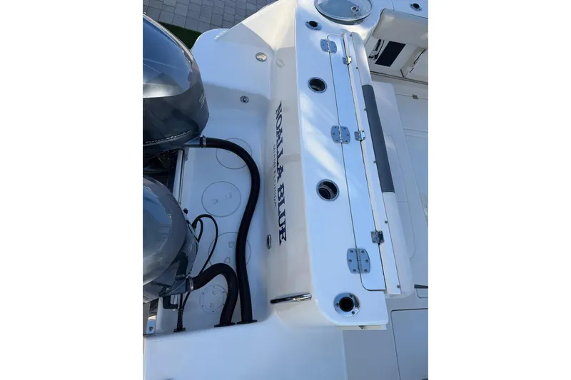  Yacht Photos Pics 2017 Robalo R302 Center Console boat deck with dual engines and storage compartments.