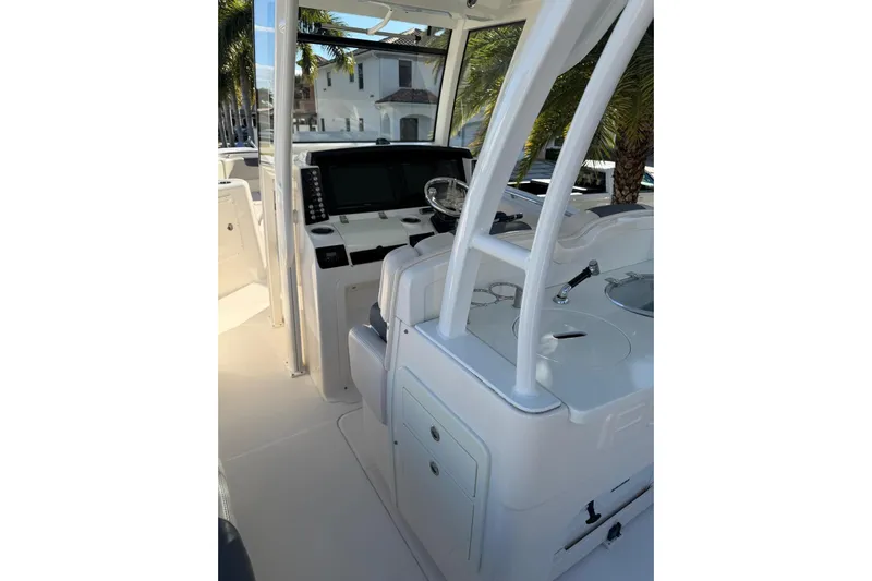  Yacht Photos Pics 2017 Robalo R302 Center Console boat interior with helm and seating area.