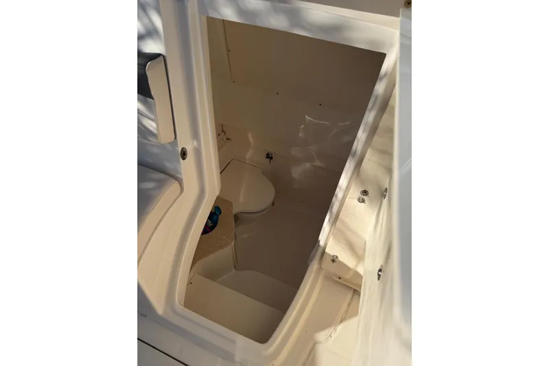  Yacht Photos Pics 2017 Robalo R302 Center Console interior cabin with seating and storage.