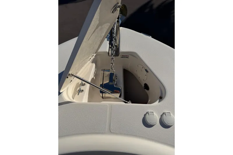  Yacht Photos Pics 2017 Robalo R302 Center Console anchor compartment with open hatch and chain mechanism.