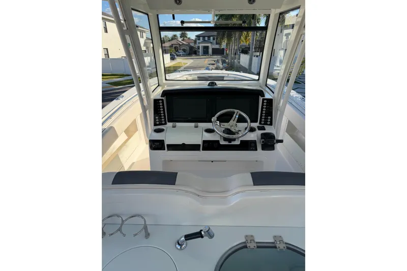  Yacht Photos Pics 2017 Robalo R302 Center Console boat helm with modern controls and navigation screens.