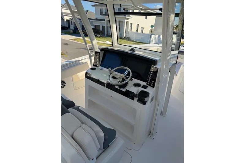  Yacht Photos Pics 2017 Robalo R302 Center Console boat interior with steering wheel and navigation controls.