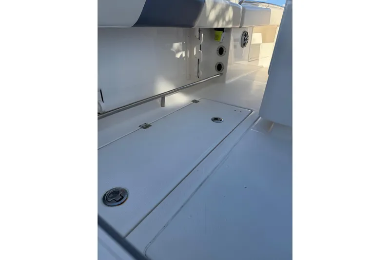  Yacht Photos Pics 2017 Robalo R302 Center Console boat interior, featuring storage compartments and seating area.