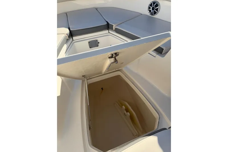  Yacht Photos Pics 2017 Robalo R302 Center Console boat with open storage compartment and cushioned seating.