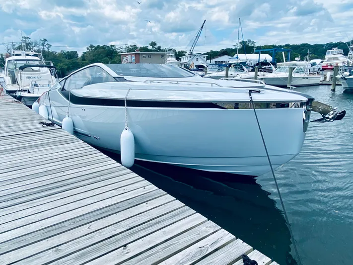 Just Us Yacht Photos Pics 2022 Fairline F//Line 33 yacht docked at marina, sleek design, calm water, cloudy sky.