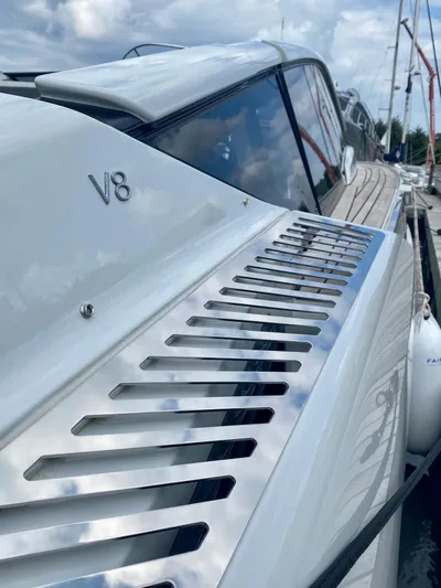 Just Us Yacht Photos Pics 2022 Fairline F//Line 33 yacht with V8 engine, sleek design, docked under cloudy sky.