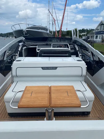 Just Us Yacht Photos Pics 2022 Fairline F//Line 33 luxury yacht with sleek design and wooden deck, docked at marina.