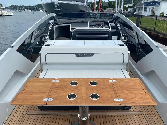 Just Us Yacht Photos Pics 2022 Fairline F//Line 33 yacht interior with wooden table and sleek design.