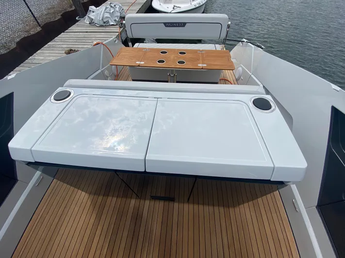 Just Us Yacht Photos Pics 2022 Fairline F//Line 33 yacht with sleek deck and modern seating area.