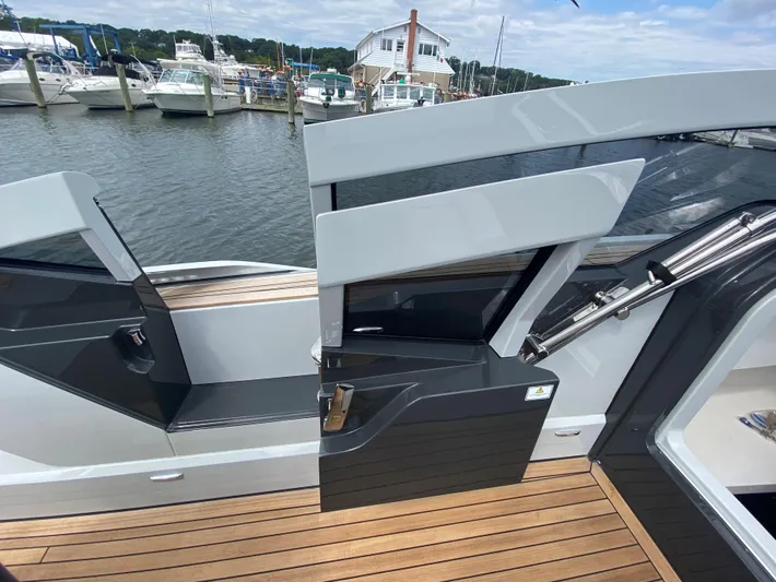 Just Us Yacht Photos Pics Fairline F//Line 33 yacht, 2022 model, docked with open door and wooden deck.