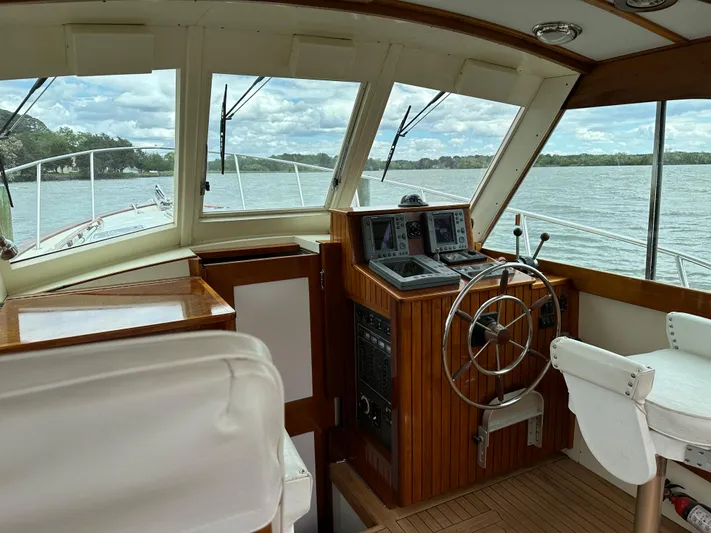  Yacht Photos Pics Interior view of 2001 Mast & Mallet 38 Picnic Boat helm with scenic water backdrop.