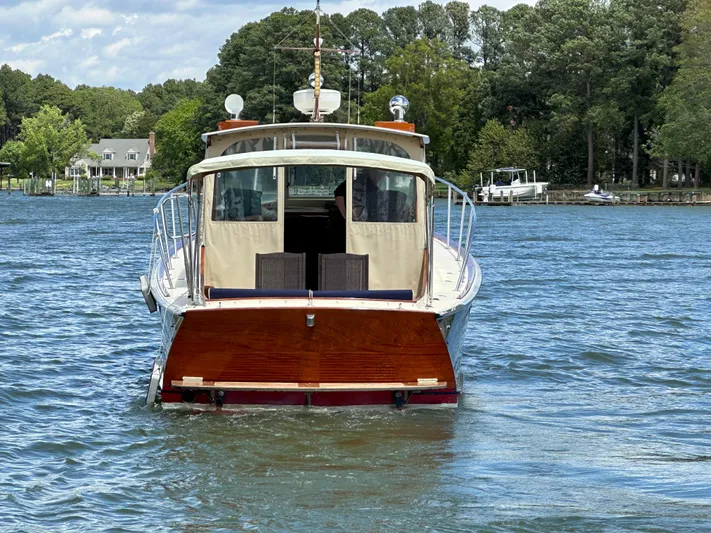  Yacht Photos Pics 2001 Mast & Mallet 38 Picnic Boat on a serene lake with lush green surroundings.