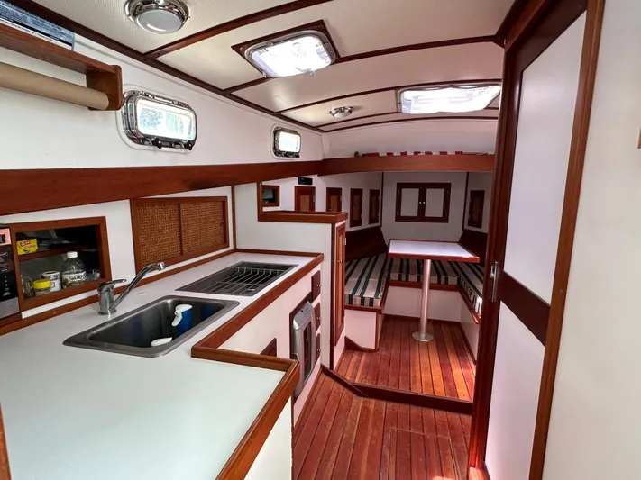  Yacht Photos Pics Interior of 2001 Mast & Mallet 38 Picnic Boat with wood accents and modern amenities.