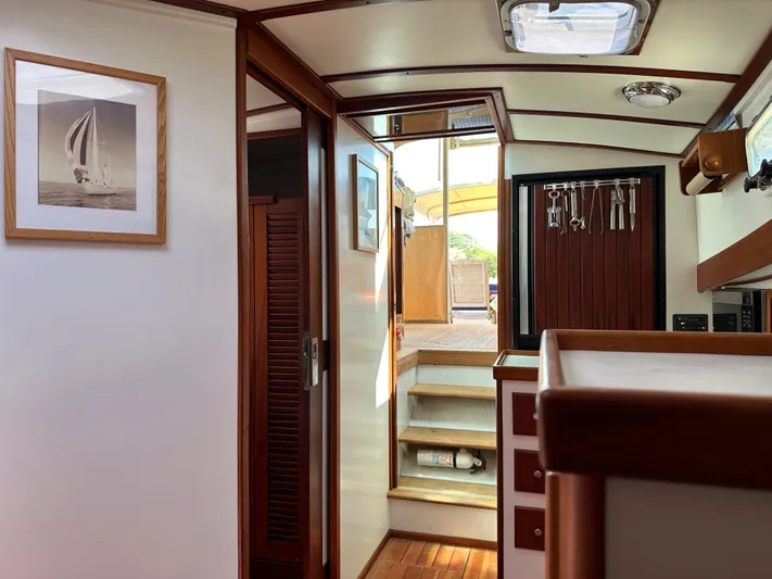 Yacht Photos Pics Interior of 2001 Mast & Mallet 38 Picnic Boat with wooden accents and framed artwork.