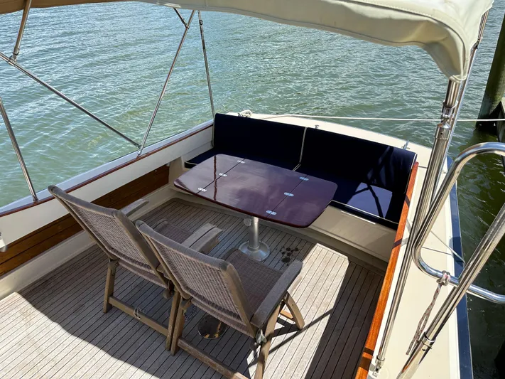  Yacht Photos Pics 2001 Mast & Mallet 38 Picnic Boat with seating area and table on deck.