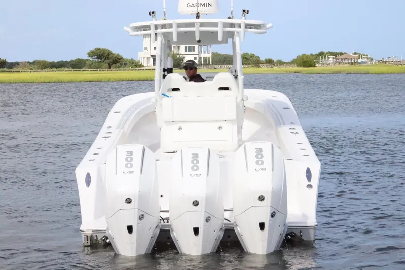  Yacht Photos Pics 2022 Onslow Bay 33 boat with triple 300 V8 engines on a calm waterway.