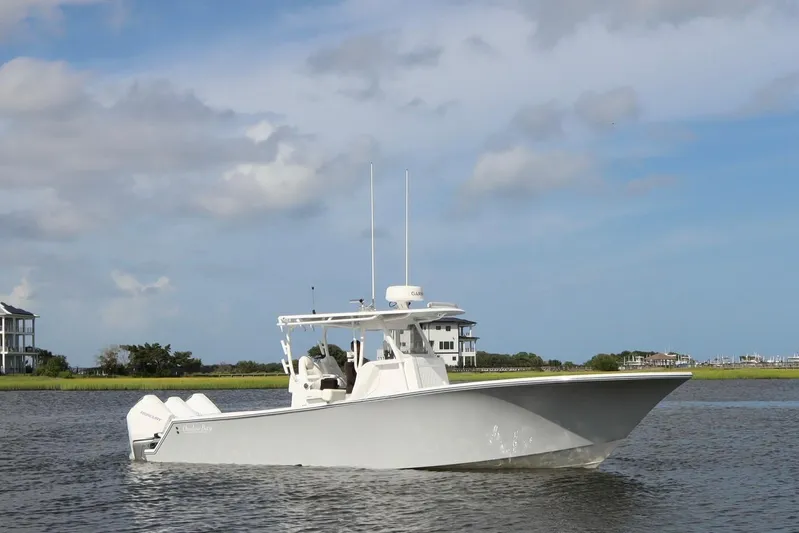  Yacht Photos Pics 2022 Onslow Bay 33 boat on calm water under a blue sky.