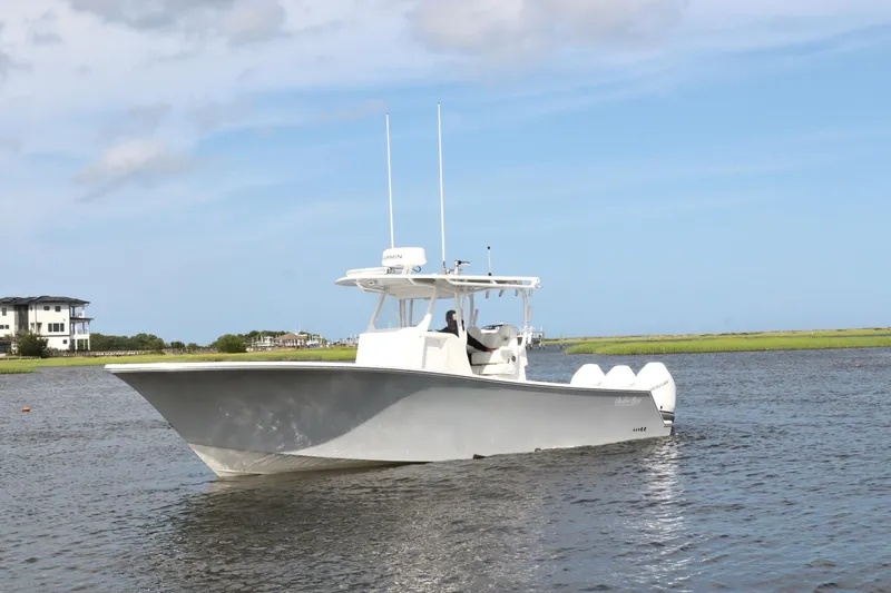  Yacht Photos Pics 2022 Onslow Bay 33 boat on calm water under a clear blue sky.