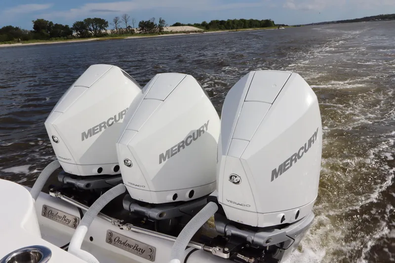  Yacht Photos Pics Triple Mercury outboard engines on 2022 Onslow Bay 33 boat, cruising on open water.
