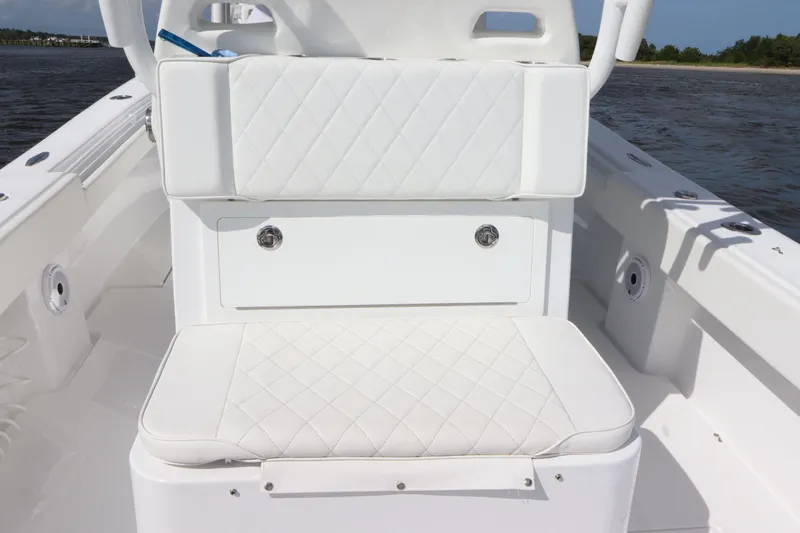  Yacht Photos Pics 2022 Onslow Bay 33 boat with white cushioned seating and storage compartment.