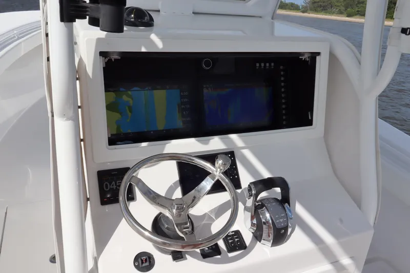  Yacht Photos Pics 2022 Onslow Bay 33 boat dashboard with steering wheel and navigation screens.