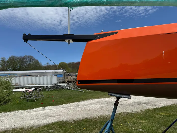 Yacht Photos Pics 2025 Saffier 24 Lite sailboat with vibrant orange hull on a stand outdoors.