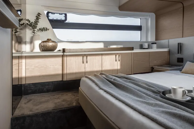 Azimut 53 Fly Yacht Photos Pics Luxurious interior of 2026 Azimut Fly 53 yacht with modern decor and cozy bedding.