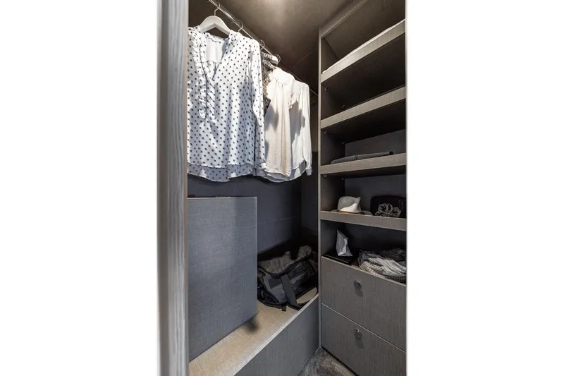 Azimut 53 Fly Yacht Photos Pics Luxurious closet in 2026 Azimut Fly 53 yacht with organized shelves and hanging clothes.