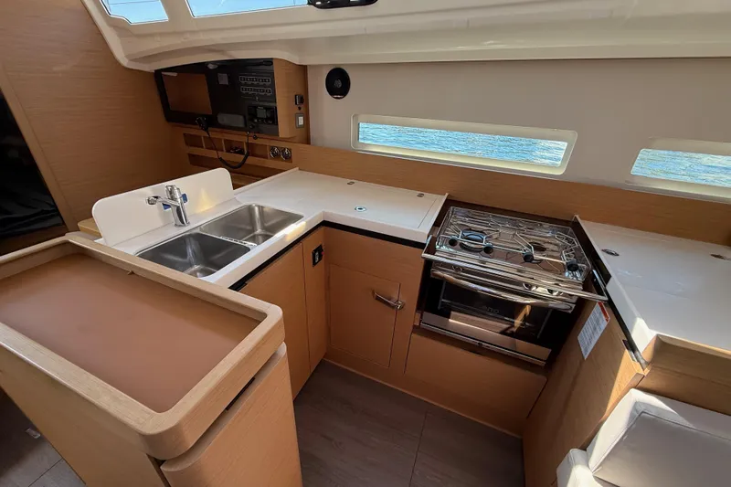 Lucky Dog Yacht Photos Pics Modern kitchen in 2023 Jeanneau Sun Odyssey 410 yacht with stove and sink.