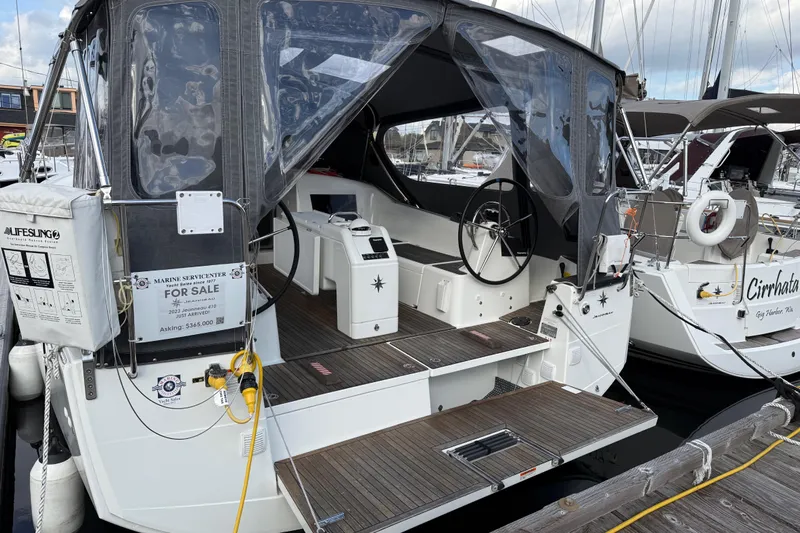 Lucky Dog Yacht Photos Pics 2023 Jeanneau Sun Odyssey 410 sailboat for sale, docked with covered cockpit.