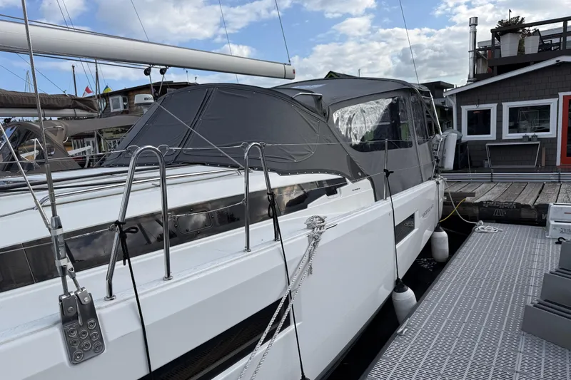 Lucky Dog Yacht Photos Pics 2023 Jeanneau Sun Odyssey 410 sailboat docked, featuring sleek design and covered cockpit.