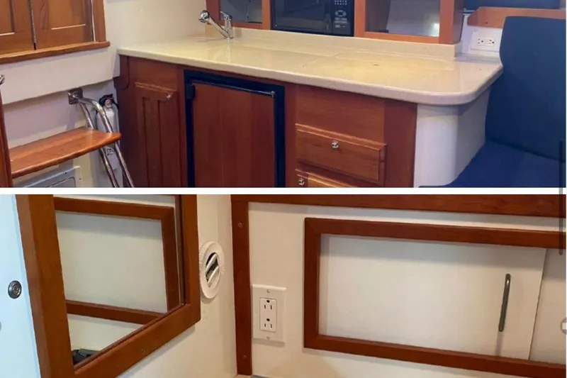  Yacht Photos Pics 2006 Back Cove 29 interior with wooden cabinetry, compact kitchen, and seating area.