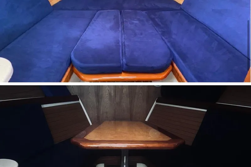  Yacht Photos Pics Interior of a 2006 Back Cove 29 boat with blue seating and wooden table.