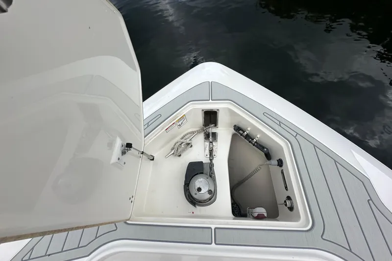  Yacht Photos Pics 2015 Boston Whaler 370 Outrage anchor compartment with open hatch, docked on water.