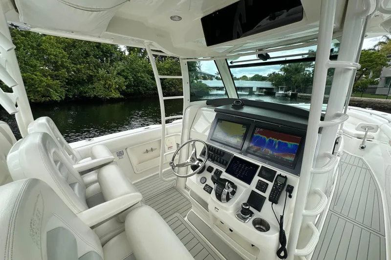 Yacht Photos Pics 2015 Boston Whaler 370 Outrage helm with advanced navigation displays and luxurious seating.