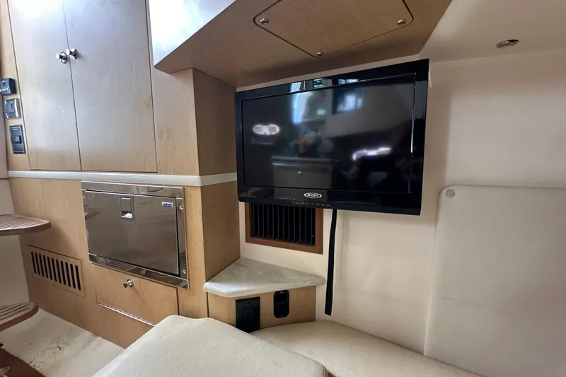  Yacht Photos Pics Interior of 2015 Boston Whaler 370 Outrage with TV and cabinetry.