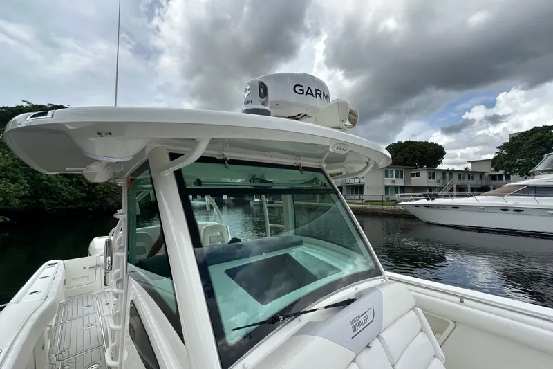  Yacht Photos Pics 2015 Boston Whaler 370 Outrage boat docked, featuring Garmin equipment under cloudy skies.
