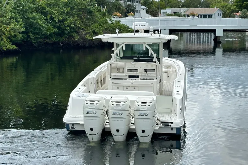  Yacht Photos Pics 2015 Boston Whaler 370 Outrage boat with triple 350 engines on a calm waterway.